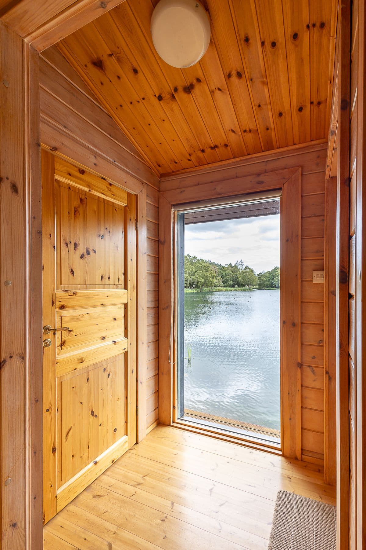 The lodge doorway opening straight onto the lake